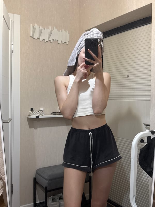 Woman takes kitchen selfies while cooking in Perm apartment