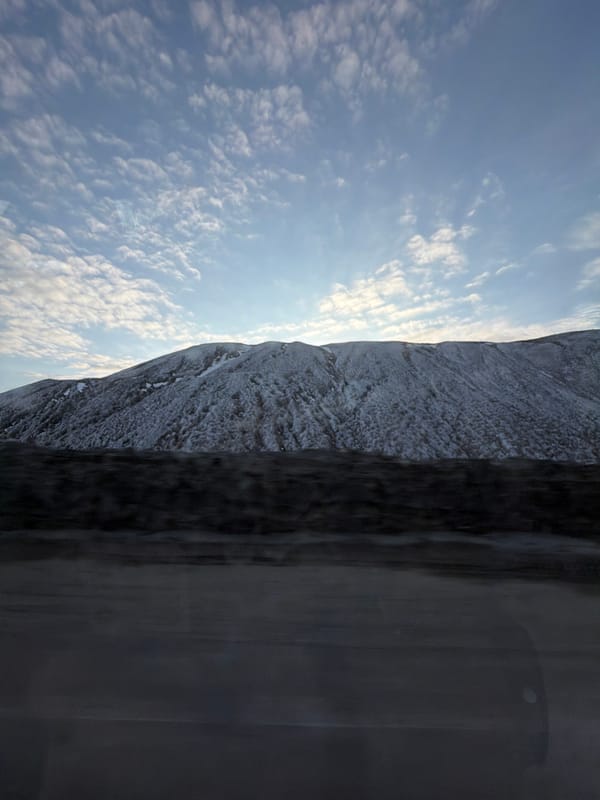 Vehicle passenger captures mountain landscape view in Solikamsk