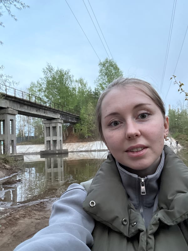 Woman photographs herself at Russian-marked concrete bridge structure