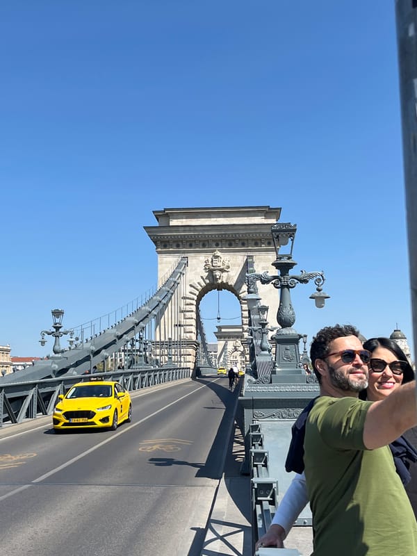 Tourists photograph Budapest landmarks on sunny Saturday morning