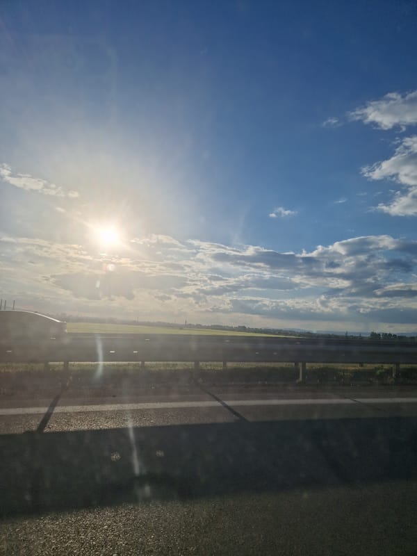Sunny highway scene captured with bright skies and clouds
