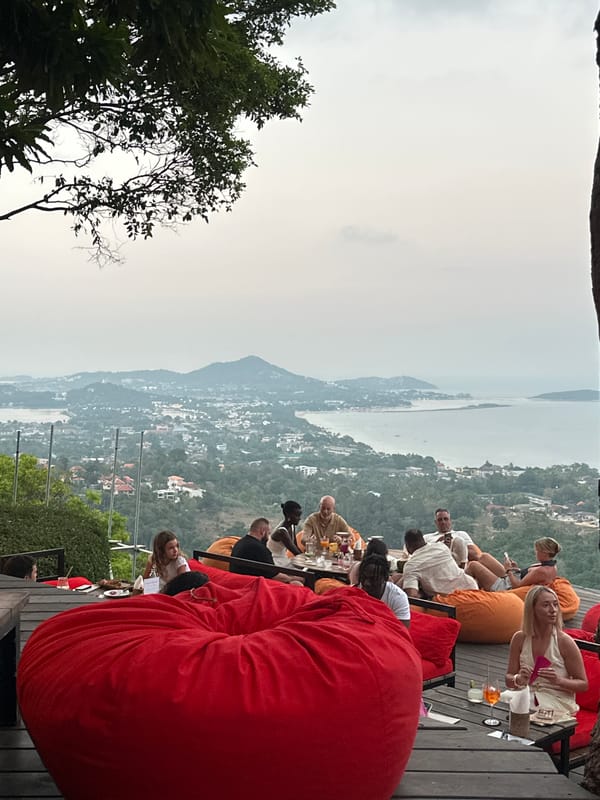 Outdoor social gathering on wooden deck in Thailand