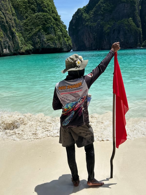 Park ranger manages tourist crowd at Ao Nang limestone beach