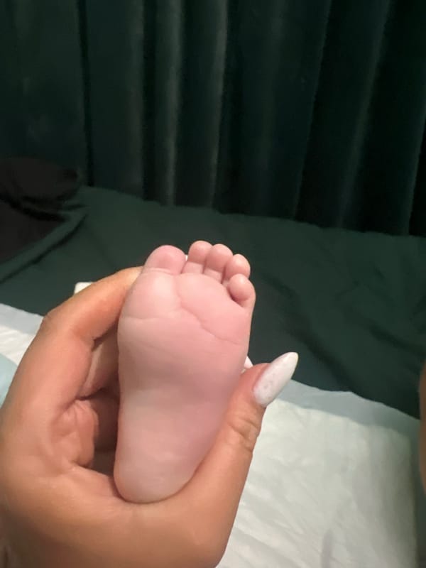 Adult holds baby's foot in Plovdiv, Bulgaria