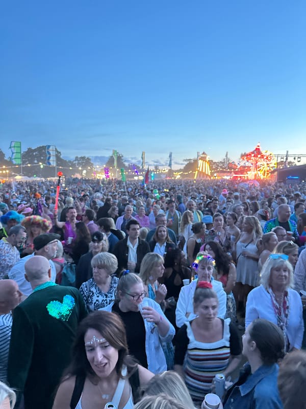 Outdoor festival at dusk, Ferris wheel and jellyfish stage decor