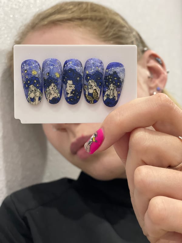 Person displays decorative nail art designs in Izhevsk