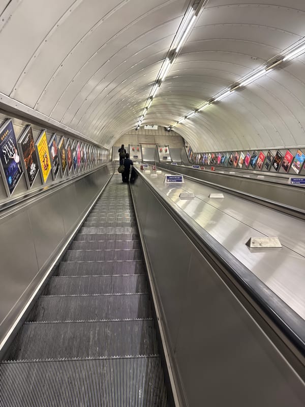 Moving through a London Underground station with luggage