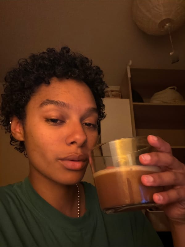 Person enjoys brown beverage in Champs-sur-Marne evening