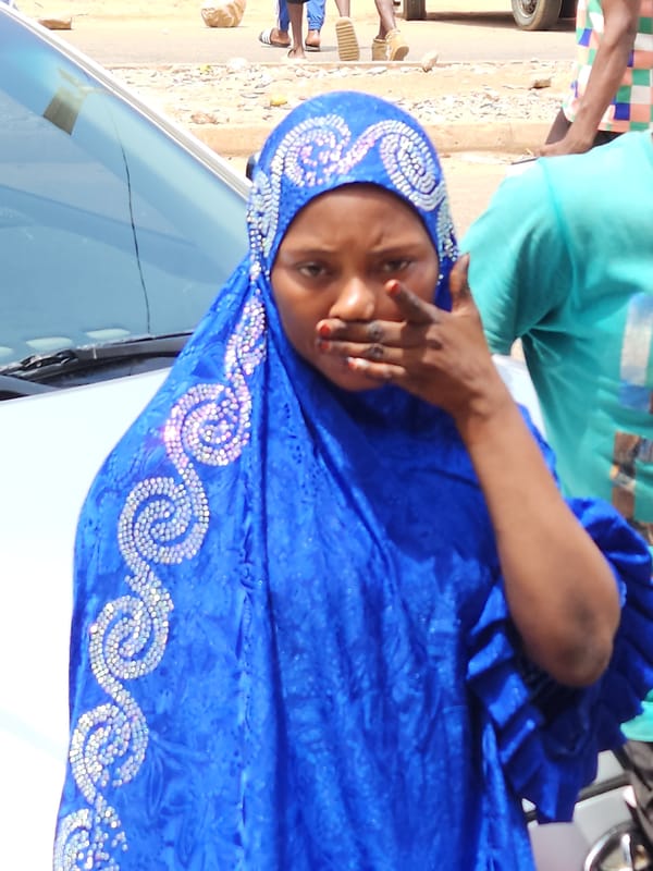 Daily street life documented outside Nigerian electronics store