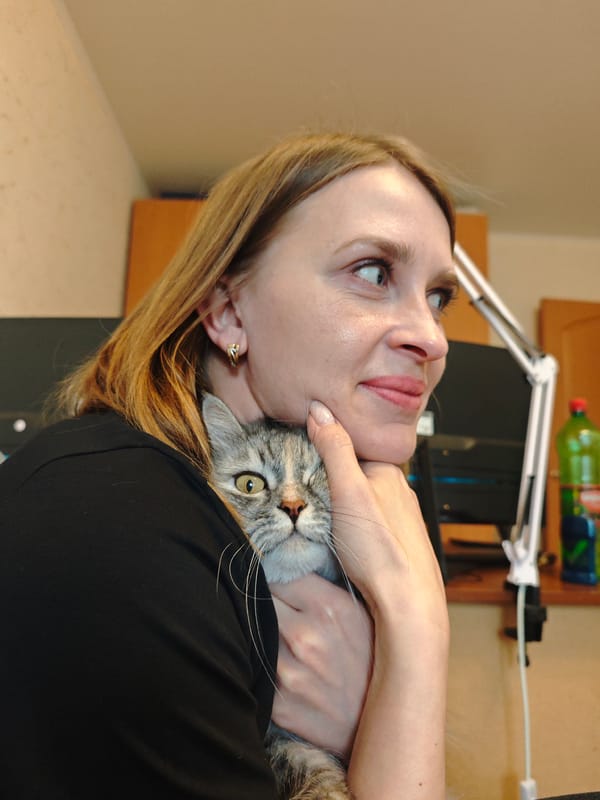 Woman poses with tabby cat in Samara, Russia