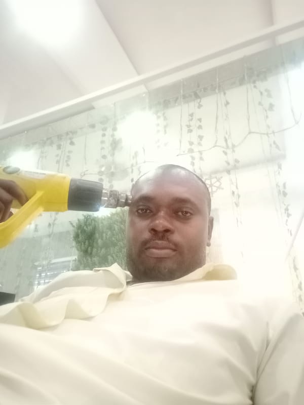 Man photographed with heat gun in indoor Gwarinpa location