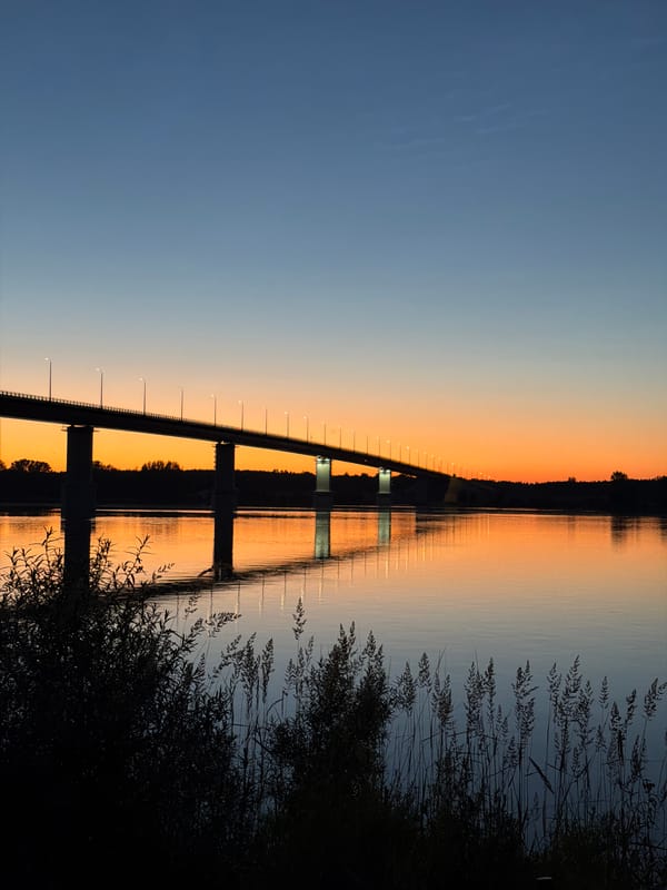 Sunset over a river bridge in Tarasovo, Russia