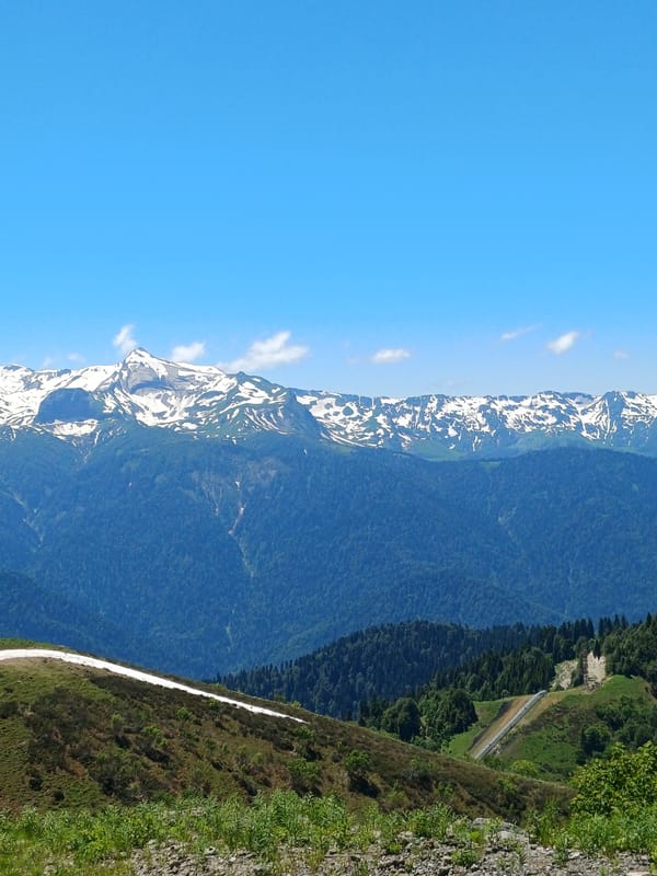 Mountain road drive through Estosadok's forested Caucasus peaks