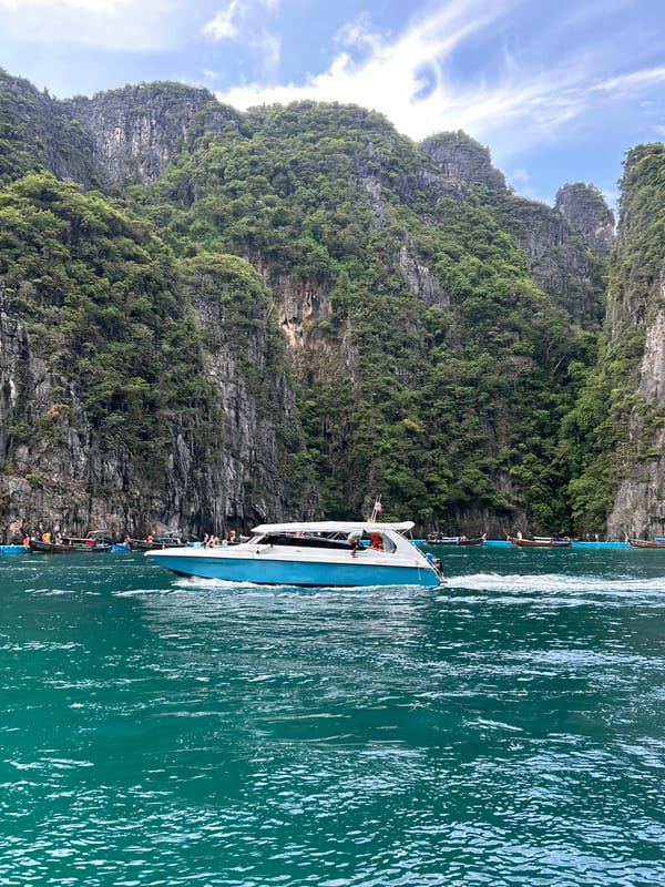 Speedboats and longtails navigate Ao Nang's limestone karst waters