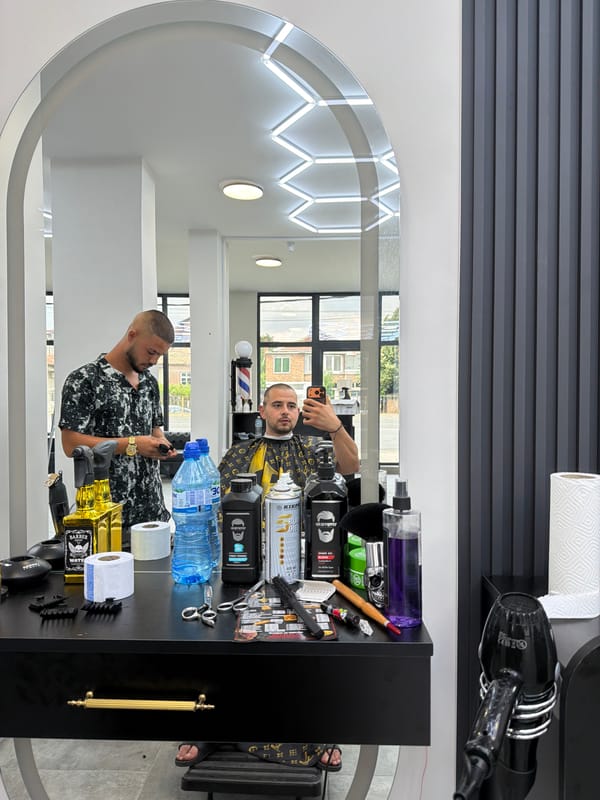 Barbershop session and wet street traffic in Burgas