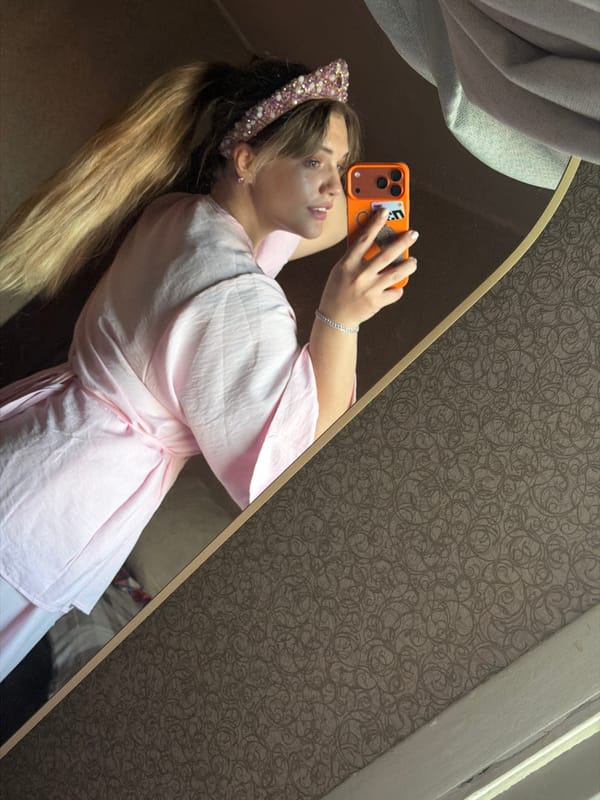 Mirror selfies with pink accessories in Naberezhnye Chelny room