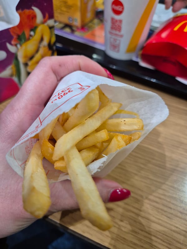 Person enjoys McDonald's fries and tea in West Suffolk