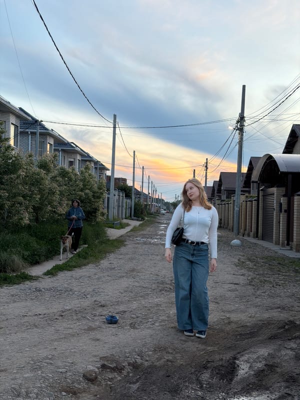 Woman poses for photos during golden hour in Rossiyskiy
