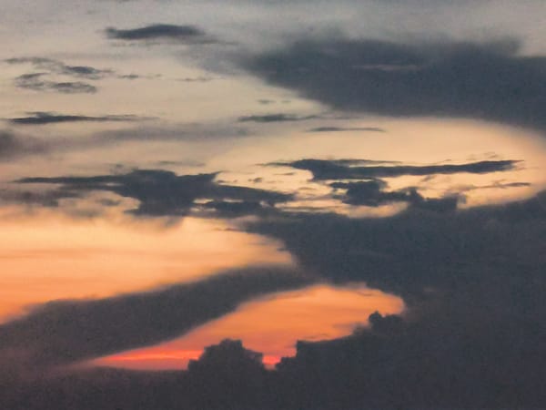 Dramatic sunset illuminates dark clouds over Lhokseumawe seascape