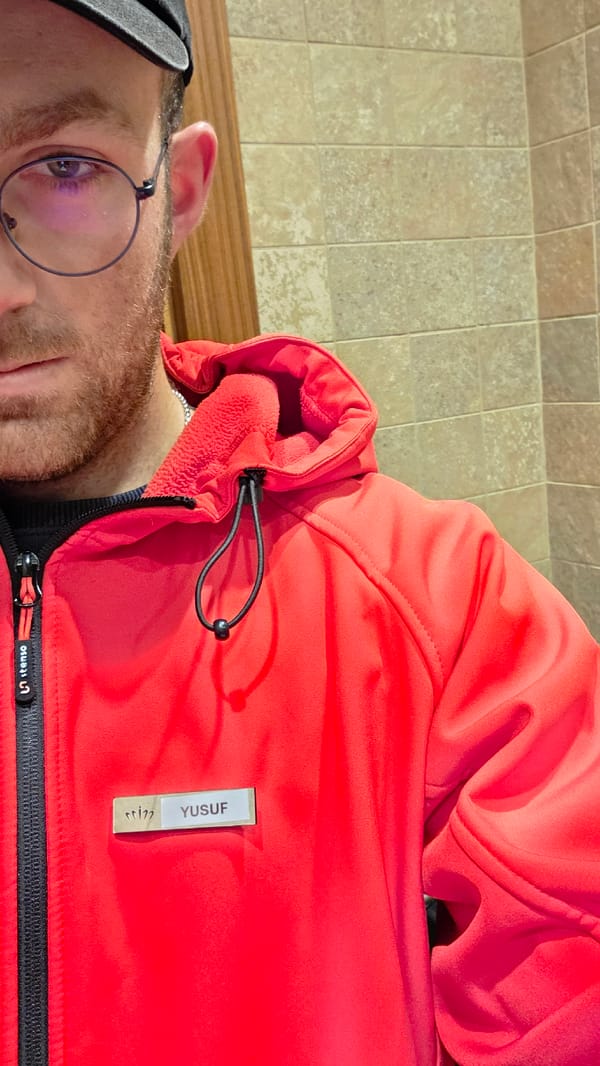 Person in red jacket takes selfie at location