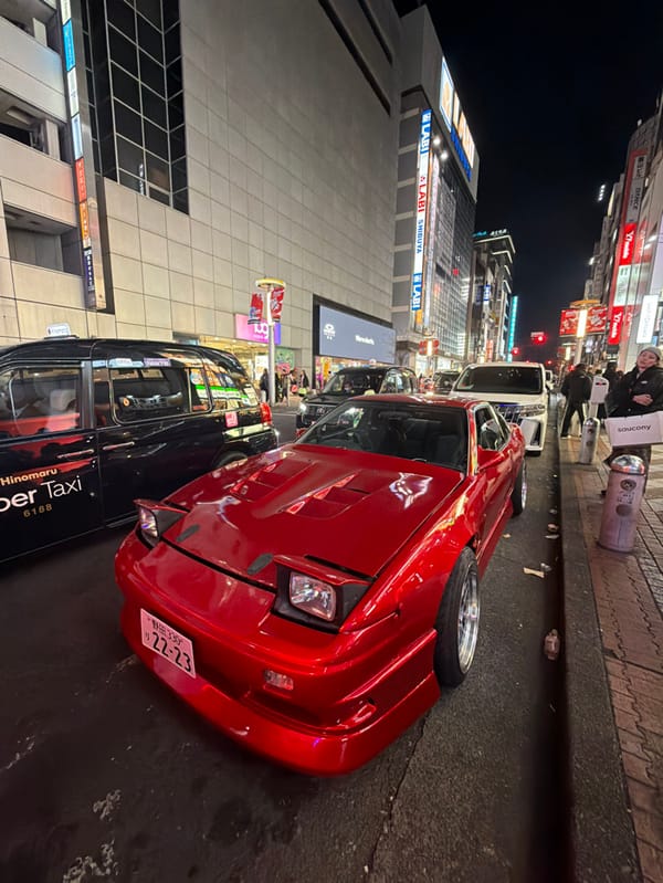 Modified red Nissan 180SX spotted in nighttime Shibuya
