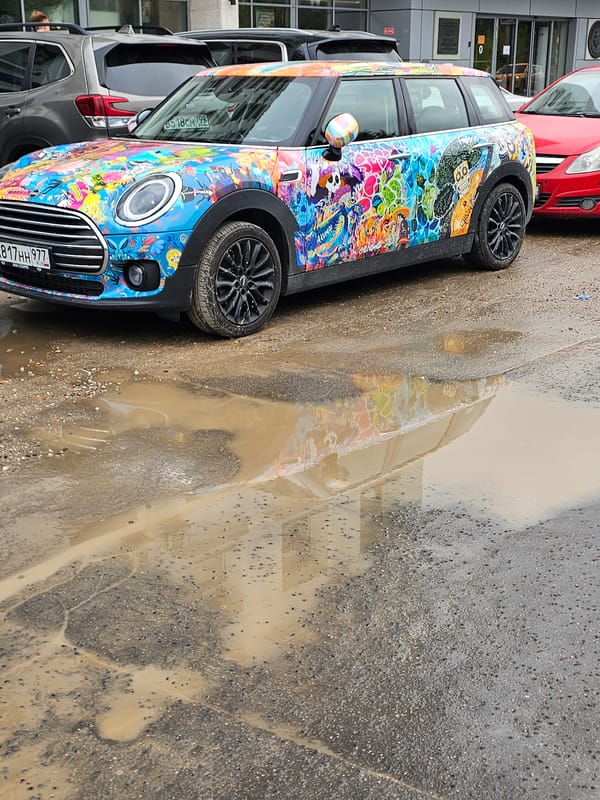 Colorful street cars spotted on wet Moscow roads
