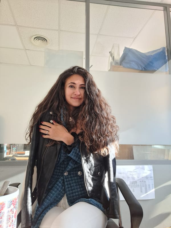 Woman enjoys morning tea in Sofia office setting