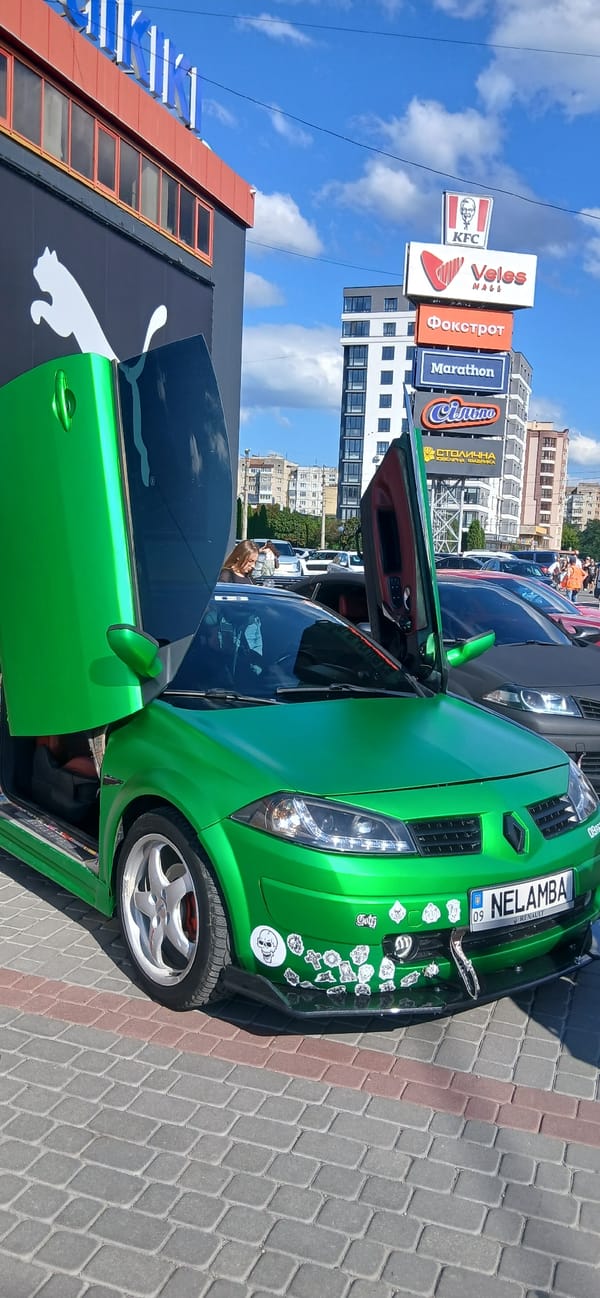 Colorful classic and sports cars at what looks like a car meet