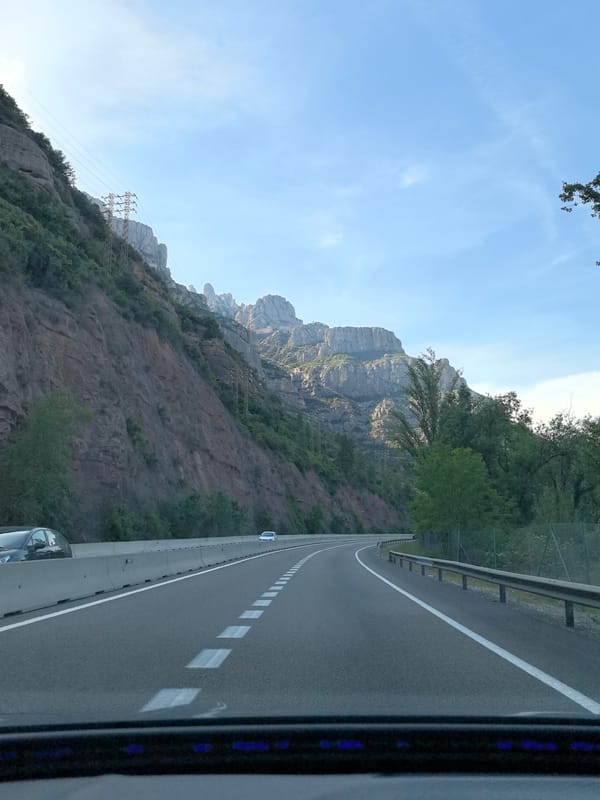 Vehicle travels curved highway near Collbató, Spain