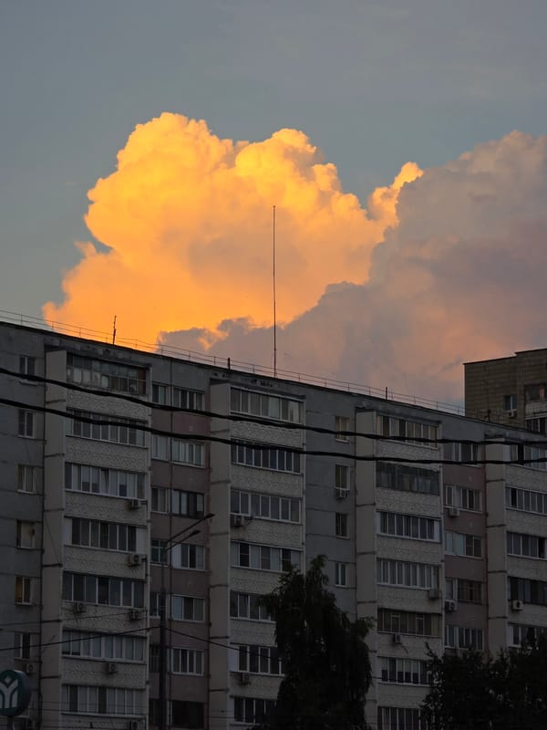 Construction site and apartment blocks at dramatic urban dusk