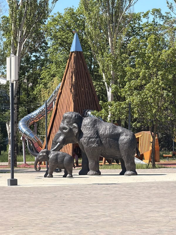 Lazy summer morning at a park with mammoth sculptures and a coffee stop