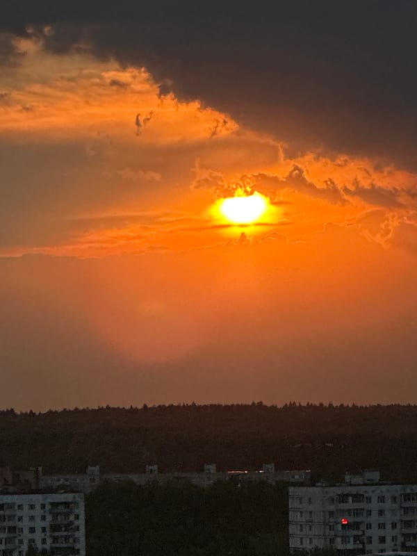 Dramatic sunset illuminates Krasnogorsk skyline with orange glow