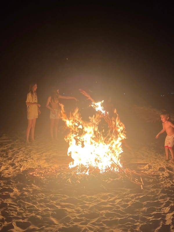 Beach bonfire gathering on the Hoi An shoreline at night