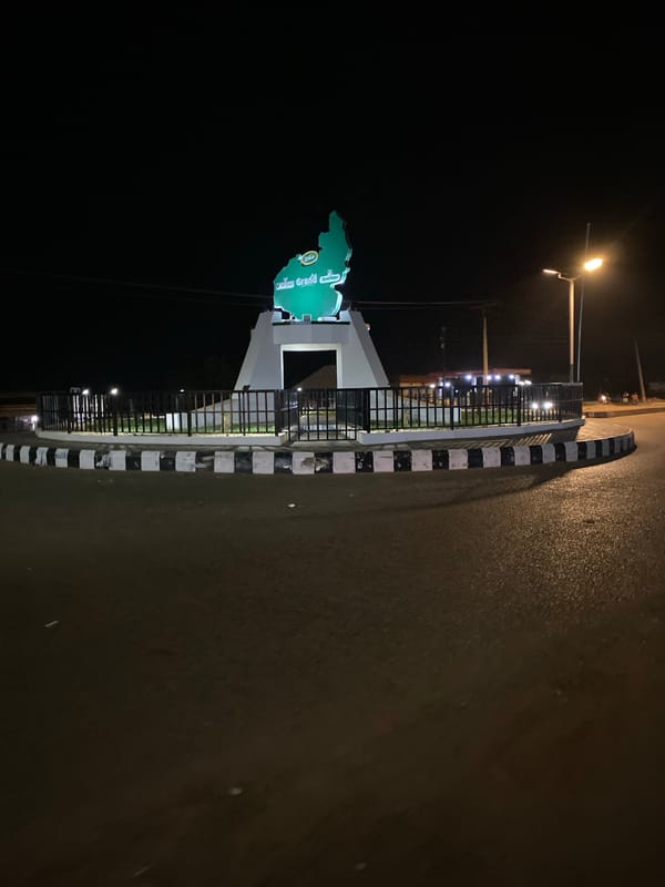 Illuminated map monument captured in nighttime Bukuru street scenes