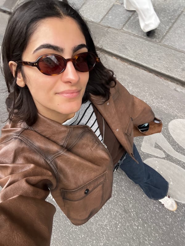 Woman takes selfies on Paris street in Montorgueil district