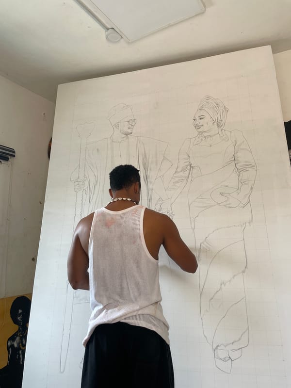 Artist creates large gridded drawing of two figures