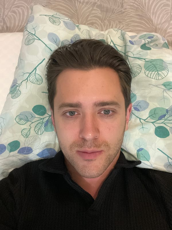 Man rests on patterned bedding in Saint Petersburg