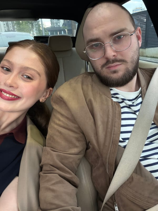 Couple photographed in car during lipstick application in Tbilisi
