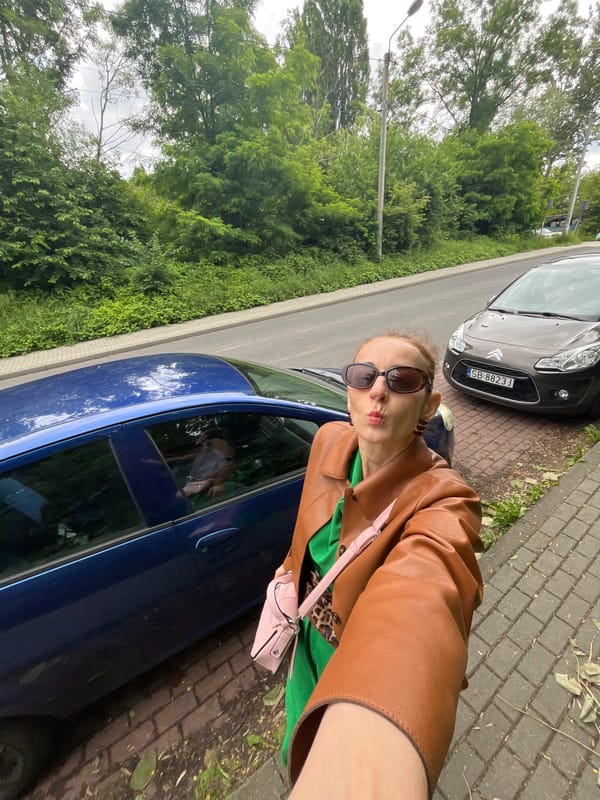 City stroll selfies near a modern church, likely Poland