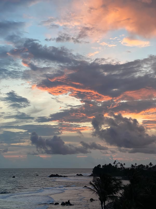 Dramatic sunset illuminates cloudy sky over Goviyapana coast