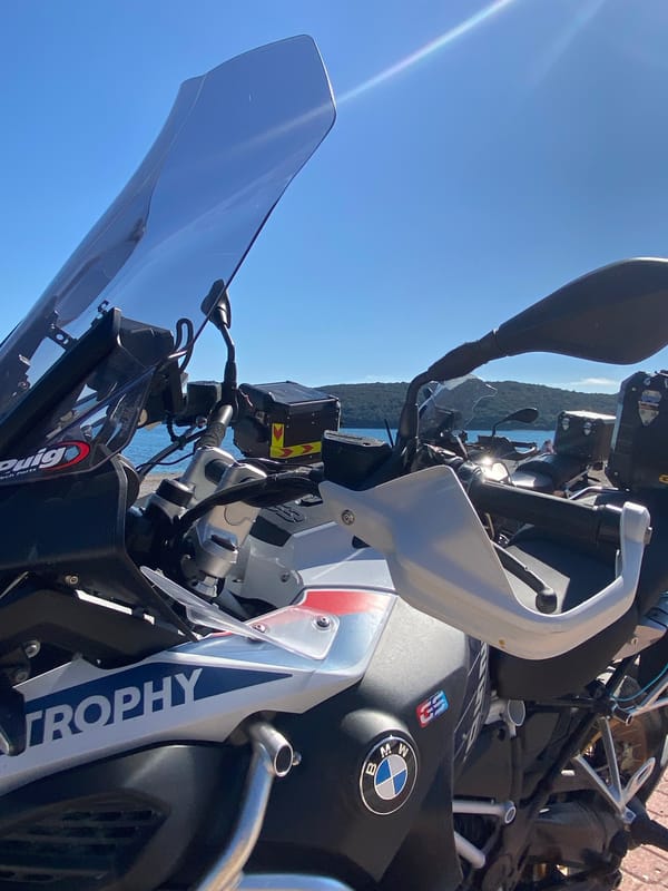 Woman relaxes on rocky beach in Prijevor, Montenegro