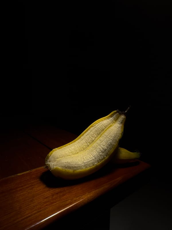 Peeled banana photographed on wooden surface in Thailand