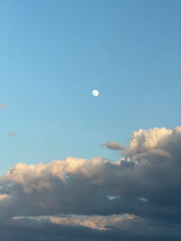 Full moon visible in daytime sky over Rignano sull'Arno