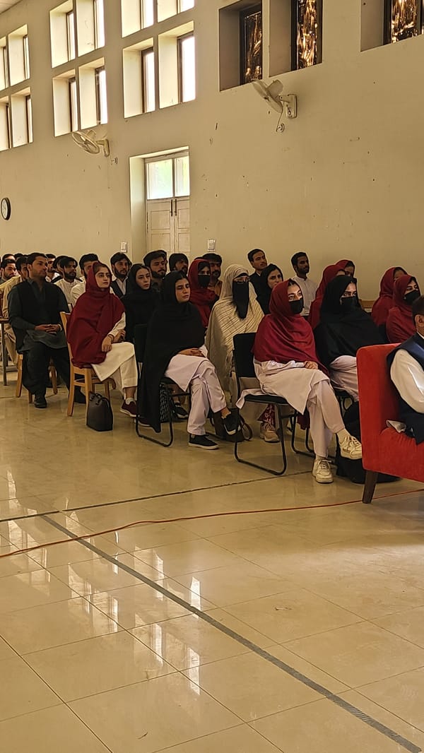 Formal conference held in Quetta auditorium with diverse audience