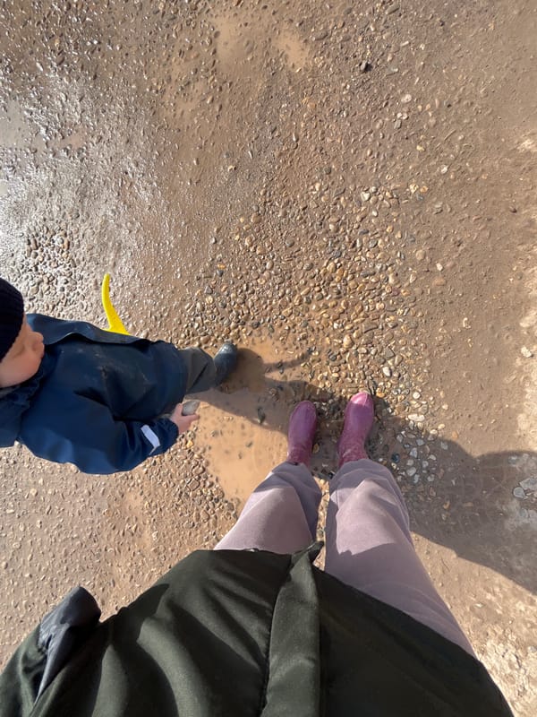 Woman documents muddy road conditions during walk in Ferma, Russia