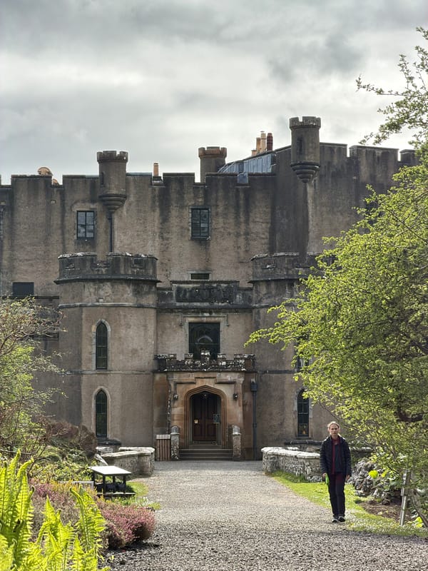 Visitors explore historic Dunvegan Castle grounds on spring afternoon