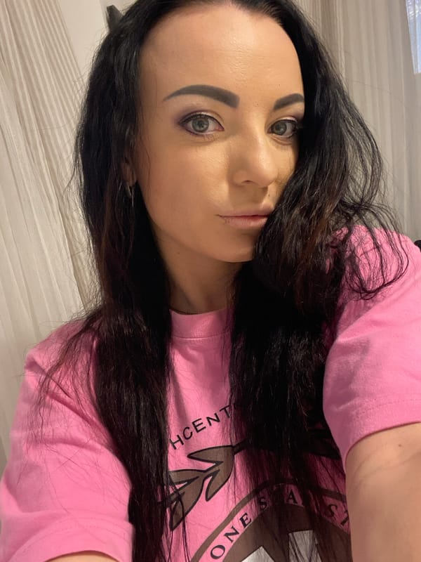 Indoor selfie showing a bold pink graphic tee in Sharm El Sheikh