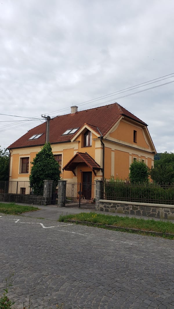 Prešov streets, waterways, and buildings on a quiet July morning