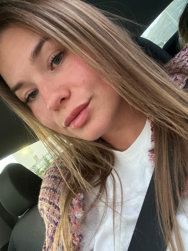 Woman takes selfie in colorful tweed jacket in Budva