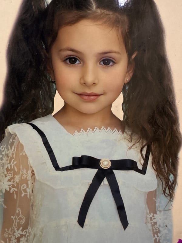 Portrait of young girl in white dress documented